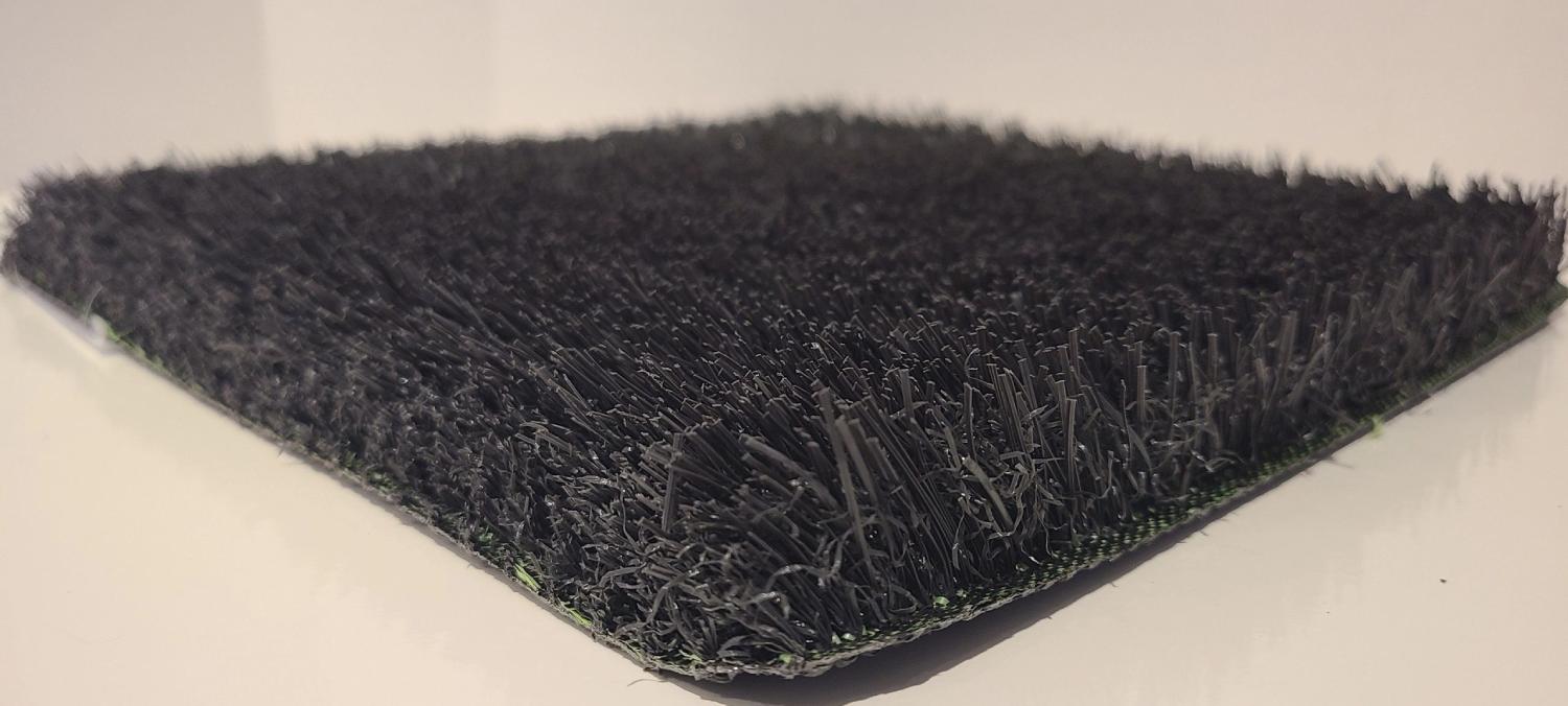 Close-up view of black artificial grass with dense synthetic fibers and textured surface, suitable for decorative landscaping and modern design applications.