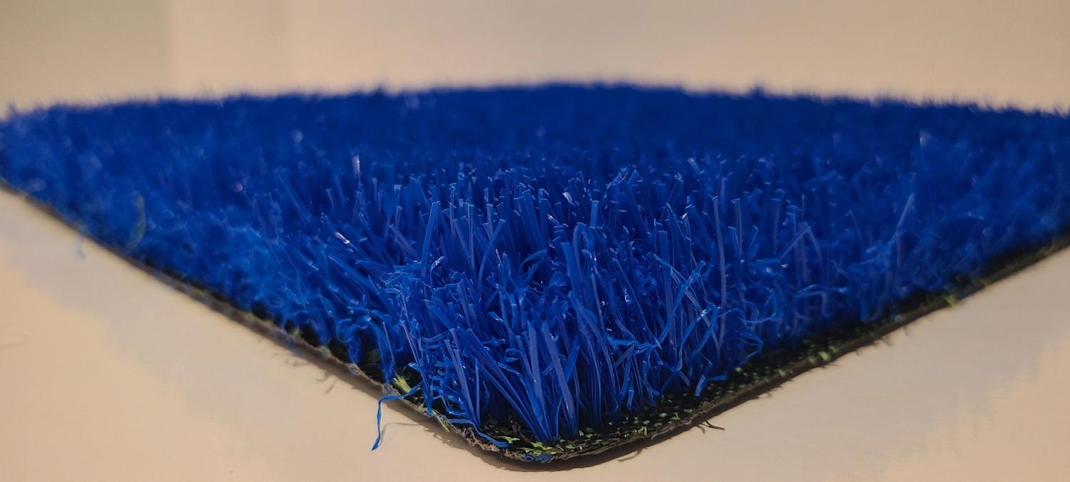 Close-up view of blue artificial grass with dense synthetic fibers and vibrant color, used for sports surfaces and decorative applications.
