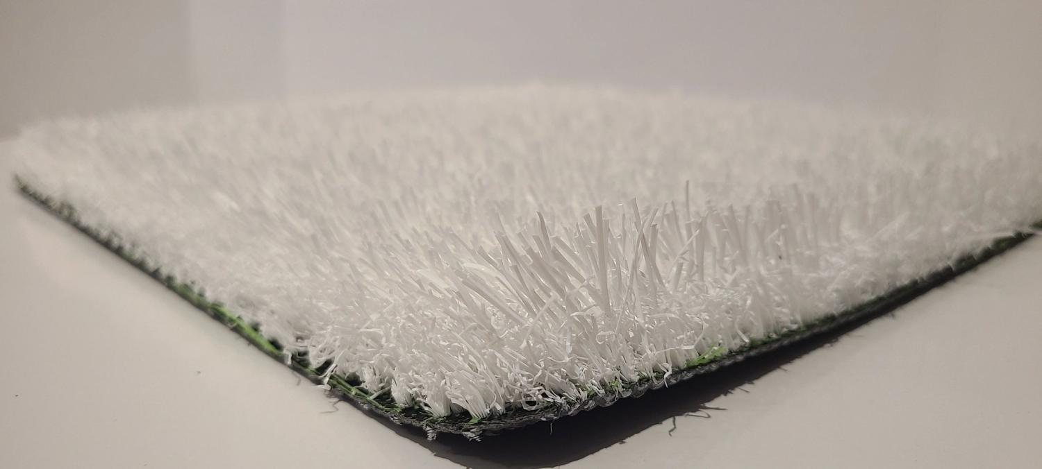 Close-up view of white artificial grass with dense synthetic fibers and clean texture, ideal for decorative, sports, or modern design applications.
