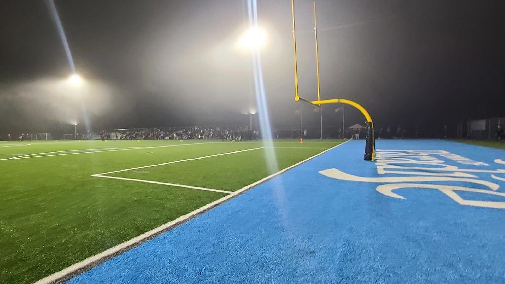 night-game-synthetic-football-field-blue-endzone.